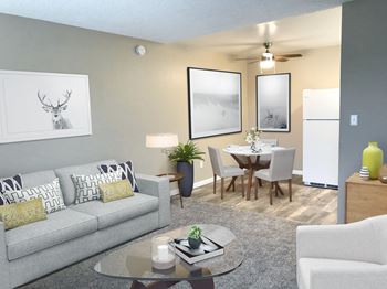 a living room and dining room with a couch and a table at Woodland Crossing , California